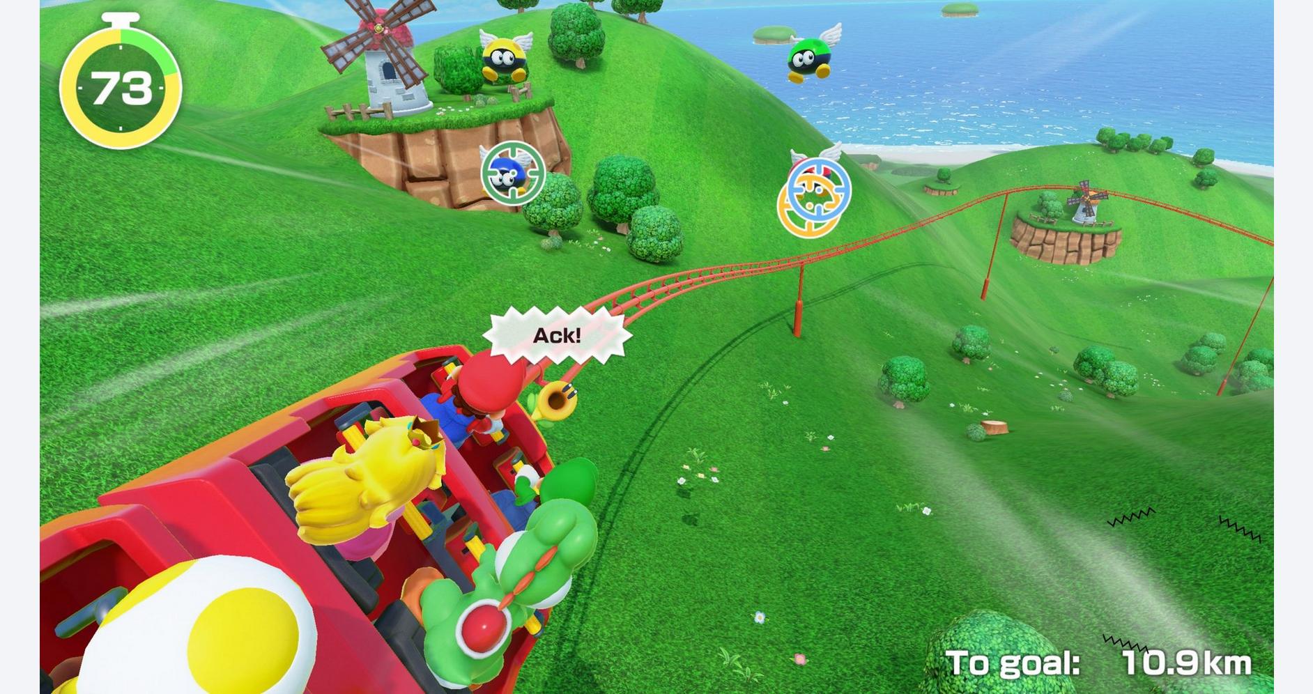 Screenshot of Super Mario Party Jamboree gameplay, showing Mario and Luigi driving a red kart on a grassy course with windmills and obstacles. The timer displays '73', and the distance to the goal is '10.9km'. A speech bubble with 'Ack!' indicates an event or challenge