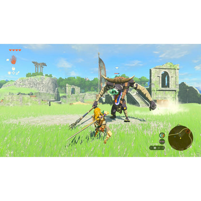 "In-game screenshot from The Legend of Zelda: Tears of the Wild – Nintendo Switch 2, showing Link engaged in a dynamic battle against enemies in a rocky terrain."